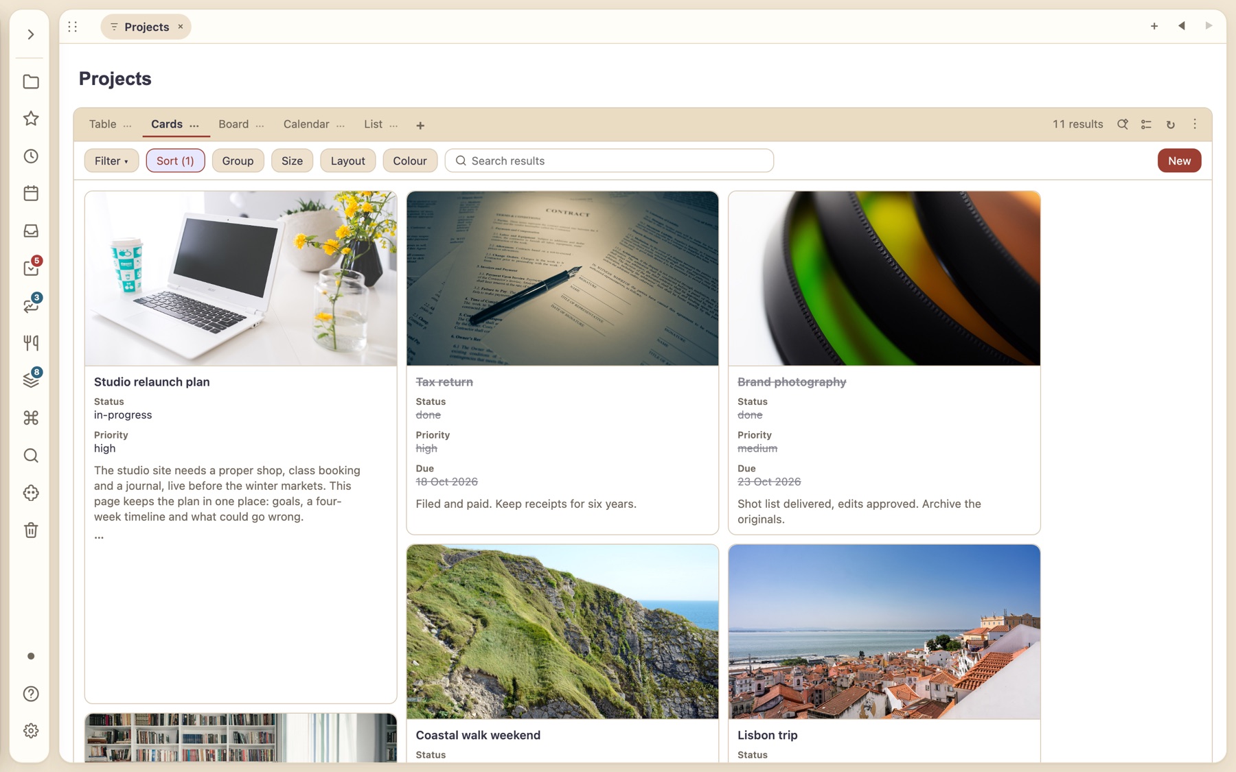 Projects as cards with cover photos, status, priority and due date